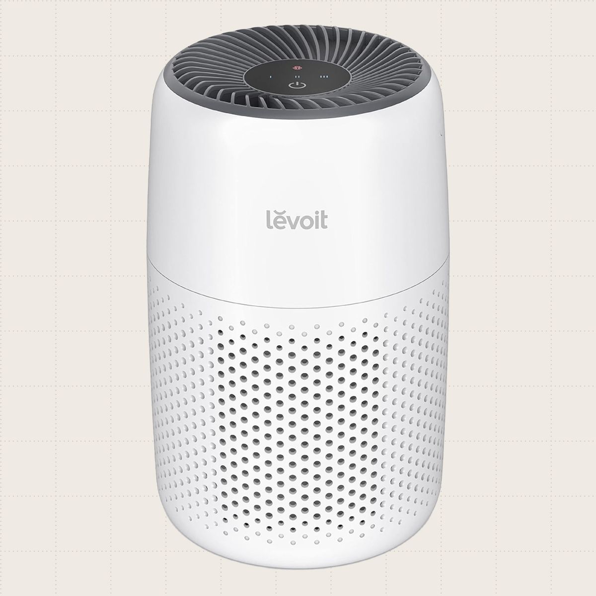 LEVOIT Core Mini Air Purifier, which is small enough to fit on a desk or countertop, shown against a beige background.