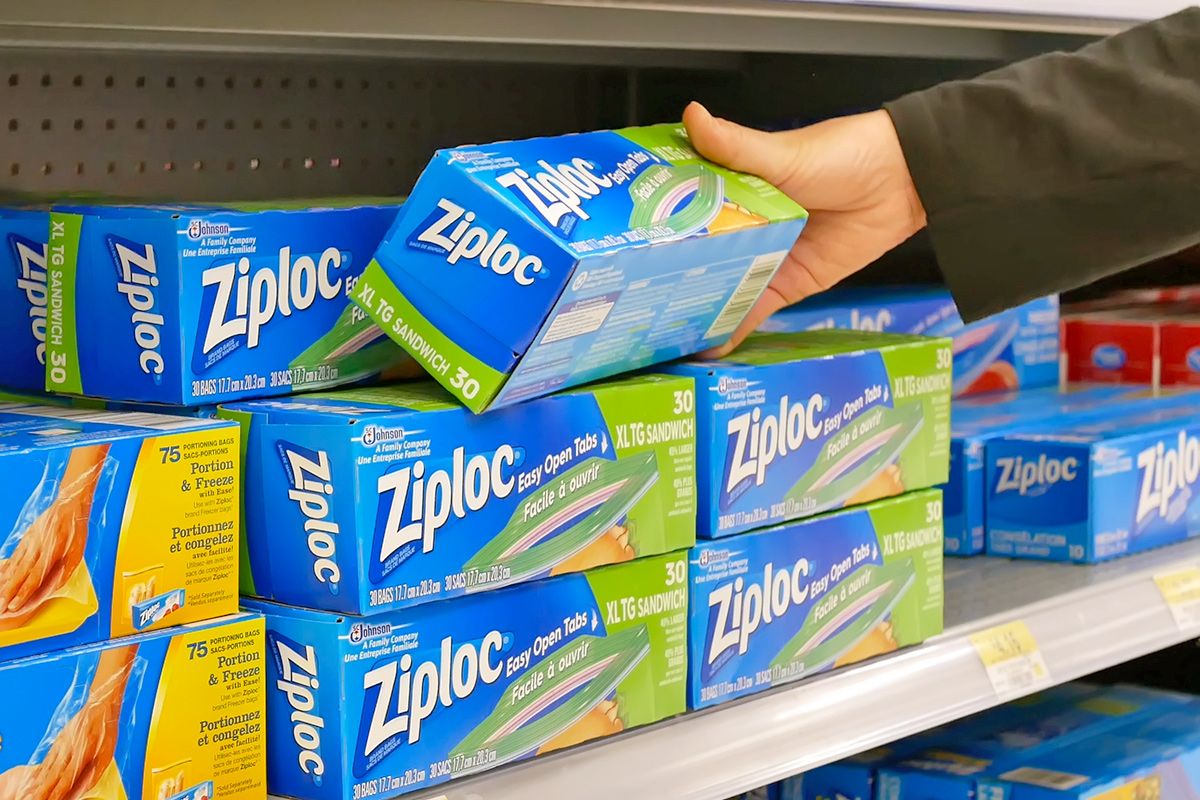 Anonymous person pulling a box of Ziploc sandwich bags off the shelf at a Walmart.