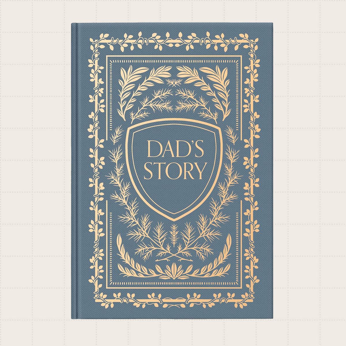 A dusty blue journal with a gold design on the cover that says "Dad's Story."