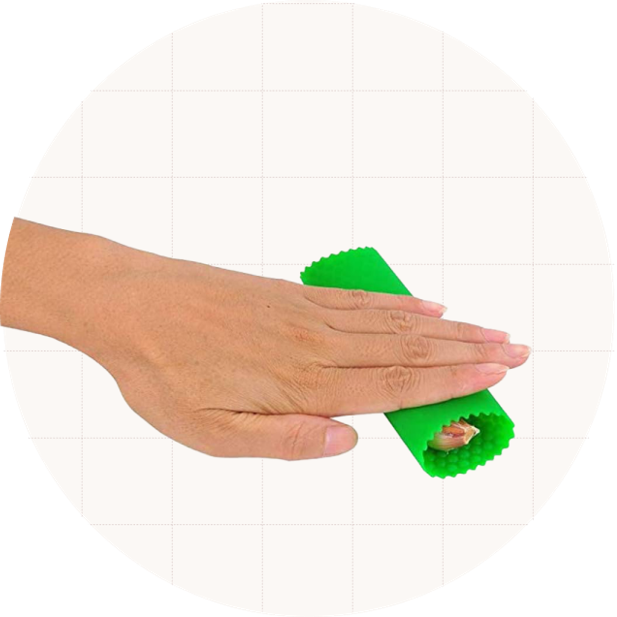 A hand rolling the Sinnsally Garlic Peeler, which is a silicone tube that peels off the skins.