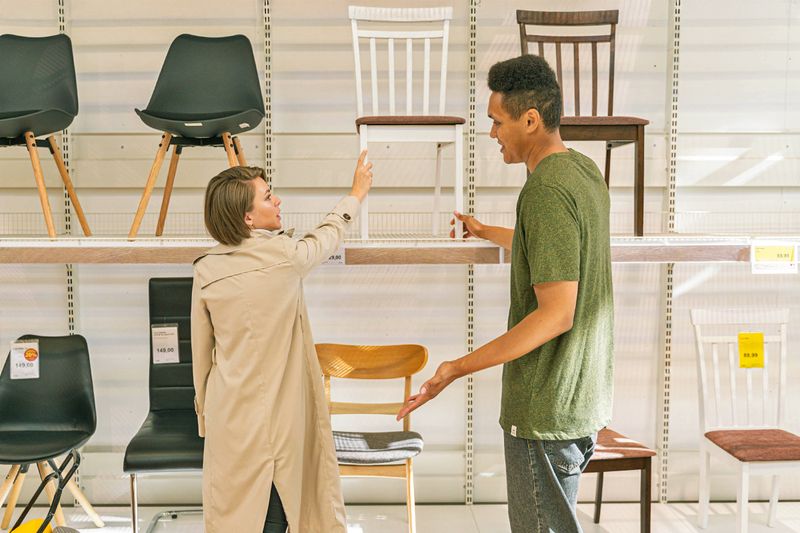 A couple shopping for dining chairs at IKEA.