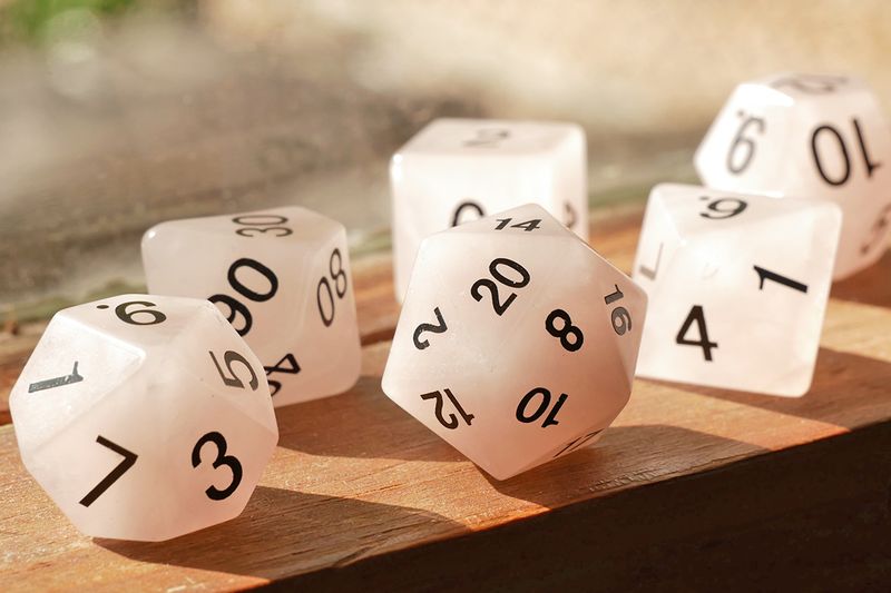 Close-up of polyhedral dice on a wooden surface